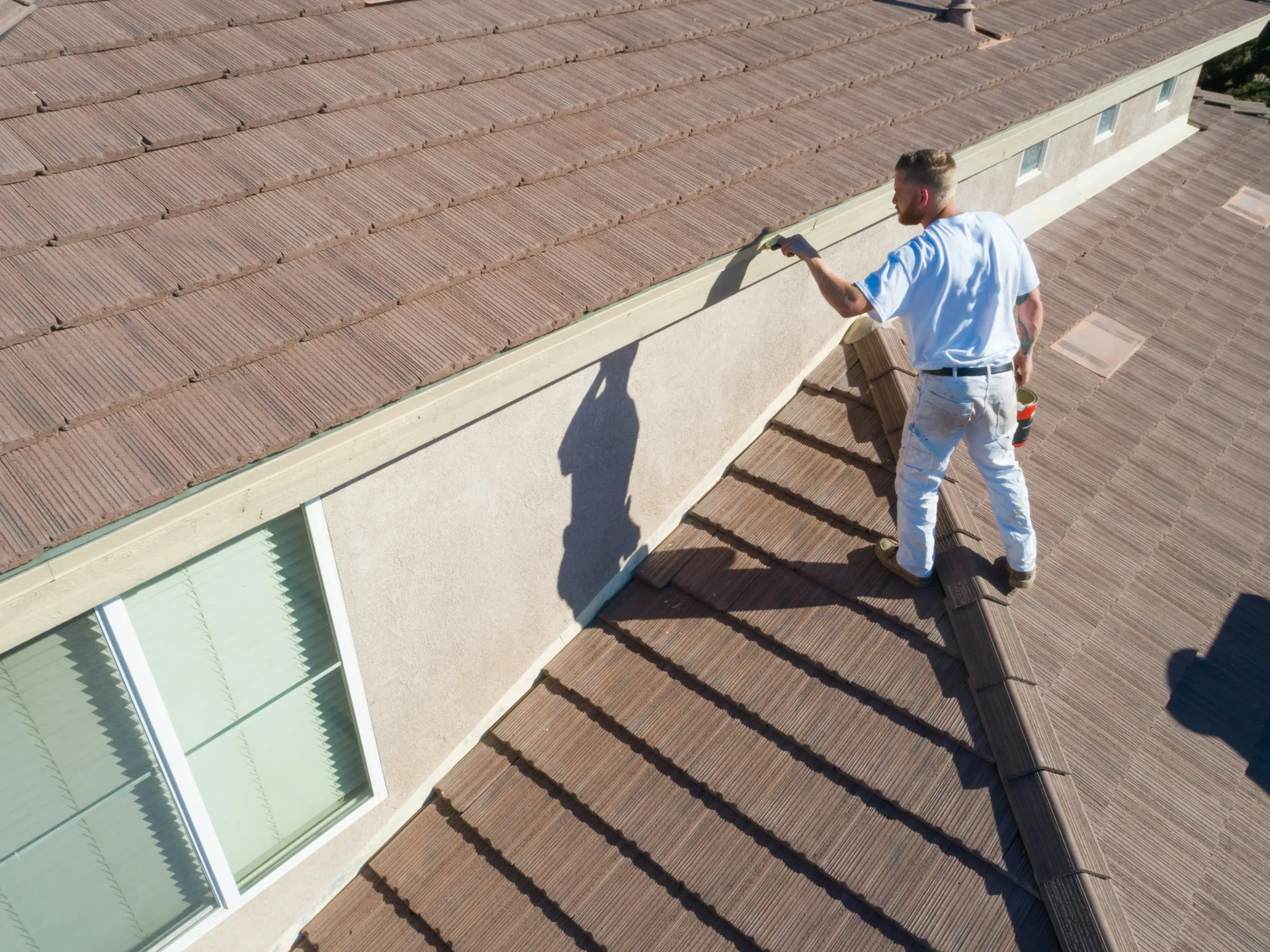 Experienced roofer working on a tiled roof, sealing the roofline during a maintenance visit. Foster and Son Roofing Services ensures thorough care for pitched roofs in Spalding and Peterborough.